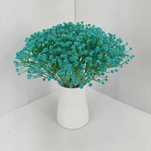 Teal artificial baby's breath flowers in a white textured vase for indoor wedding decor