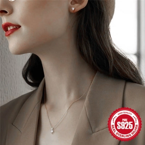 S925 sterling silver heart jewelry set with necklace and earrings worn by a model