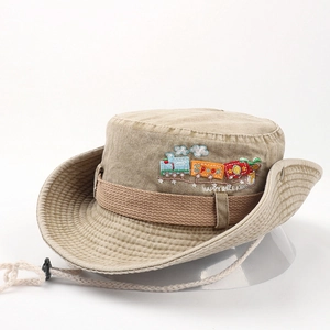 Close-up of khaki cotton sun hat with colorful cartoon train embroidery and wind cord