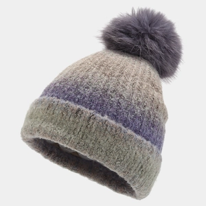 Detail of purple and beige tie-dye knit beanie featuring a large faux fur pompom top