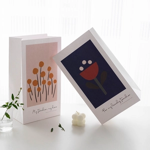 Elegant white floral gift bags for teachers with minimalist aesthetic and sturdy paper handles