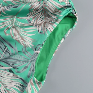 Detail of high-density flat seam stitching on tropical palm leaf print stretch fabric