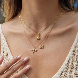 Three-layer gold necklace set with dragonfly and flower pendants encrusted with zircons