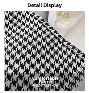 Detailed macro view of the classic black and white houndstooth fabric texture and weave