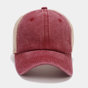 Detail of vintage trucker hat with deep red washed denim and breathable beige mesh