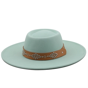Detailed texture of mint green wool fedora hat with brown studded leather band