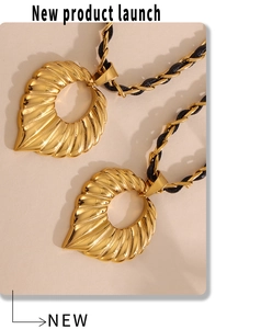 Macro shot of 18k gold plated leaf pendant with elegant textured ripple details