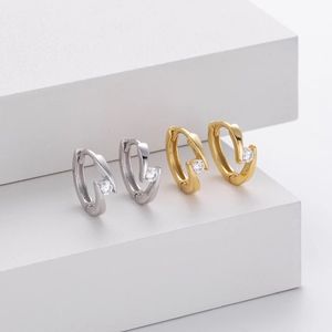 Detailed close-up of 925 sterling silver hoop earrings with round zircon stones