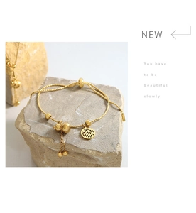 Macro detail of gold-plated stainless steel gourd bracelet with adjustable slide clasp