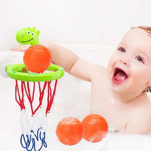 Green dinosaur bathtub basketball hoop with three orange balls for toddler bath time fun