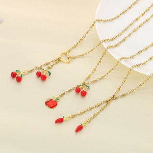 Gold chain necklace featuring red cherry, apple, and chili fruit pendants with heart clasp