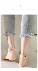 Close-up of pink low-cut cotton sock featuring cute white rabbit cartoon embroidery