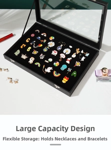 Black badge display case with glass lid showing large capacity storage for brooches