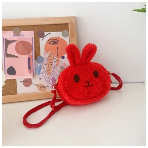 Close-up of red plush bunny crossbody bag with soft lamb wool texture and braided strap