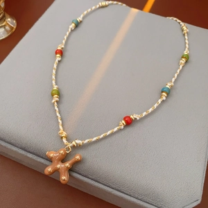 Detailed view of handmade woven necklace with colorful beads and star puppy pendant