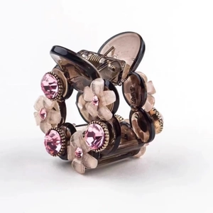 Elegant camellia hair claw clip with pink crystals and translucent brown resin