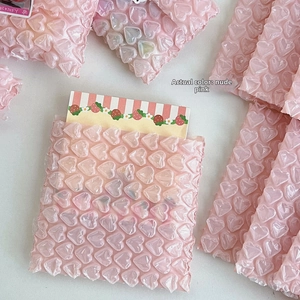 Detailed macro view of heart-shaped bubble wrap packaging in a nude pink matte finish