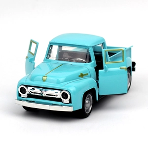 Close-up of light blue vintage alloy pickup toy car with open doors and golden details