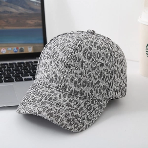 Fashionable leopard print baseball cap with wide brim on a lifestyle desk background
