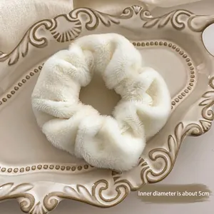 White faux fur scrunchie with 5cm inner diameter on a vintage ceramic tray