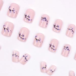 Elegant press-on nails featuring light pink base and blue floral patterns on short square shape