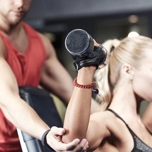 Red spiral wrist coil keychain shown on wrist during gym workout for easy access