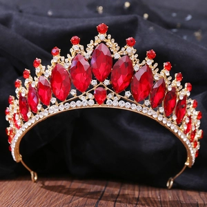 Close-up of red crystals and gold filigree on a Baroque bridal tiara with marquise stones