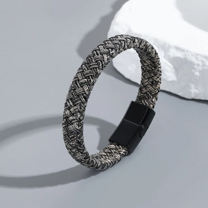 Macro detail of multi-layered braided leather bracelet with black magnetic titanium clasp