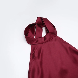 Detail of burgundy satin halter neckline with elegant twist knot and silk luster
