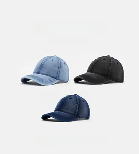 Detailed view of distressed denim baseball caps in light blue, dark blue and charcoal black