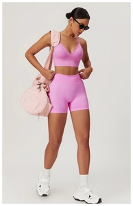 Pink V-neck sports bra and high-waist ribbed gym shorts set for professional yoga training