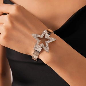 Close-up of luxury silver star open bangle featuring white pavé rhinestones on wrist