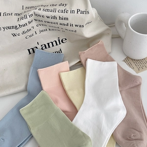 Pastel cotton crew socks in multiple colors with ribbed cuffs and minimalist aesthetic