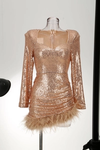 Close-up of rose gold sequin mini dress with ostrich feather hem and square neckline