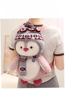 Plush penguin backpack for girls featuring a pink and white design with a knit hat and scarf