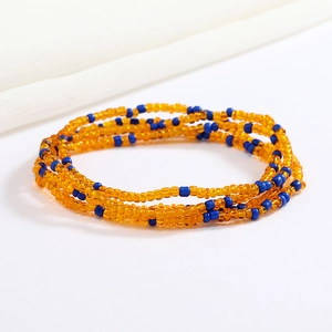 Macro detail of elastic orange and blue beaded body chain with glass seed beads