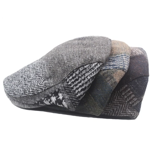 Detail view of newsboy hats showing wool blend herringbone and houndstooth patterns