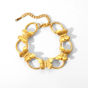 Detail of gold butterfly bracelet with brushed metal texture and adjustable lobster clasp