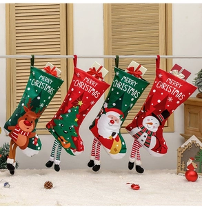 Close-up of four festive Christmas stockings with reindeer, snowman and santa patterns