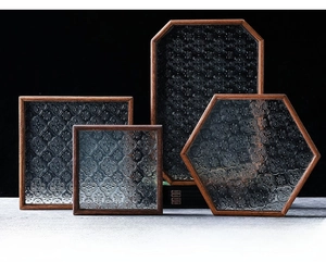 Detailed view of polygon begonia embossed glass trays with dark solid wood frames