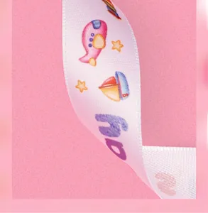 Close-up of pink ribbon with cartoon airplanes and sailboats for gift packaging