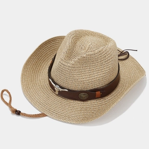 Western straw cowboy hat in beige with leather band and decorative bull head metal hardware