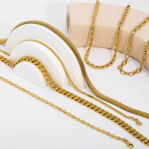 Detail of 18K gold plated stainless steel layered necklaces in various chain styles