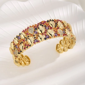 Luxurious gold-plated wide cuff bracelet featuring multi-colored cubic zirconia pavé stones