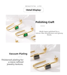 Detail view of U-shaped earrings featuring geometric cubic zirconia with thick gold plating