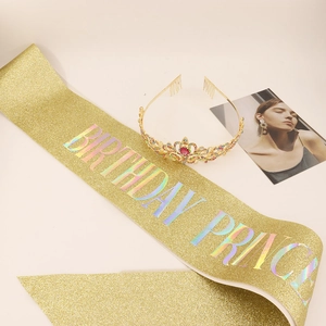 Detail of gold glitter Birthday Princess sash and sparkling rhinestone tiara set