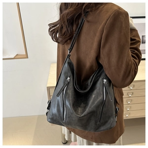 Dettaglio borsa hobo in pelle nera con eleganti cerniere argentate e stile retrò chic