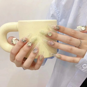 Handmade green coffin press-on nails with 3D white flowers, silver bows, and rhinestones