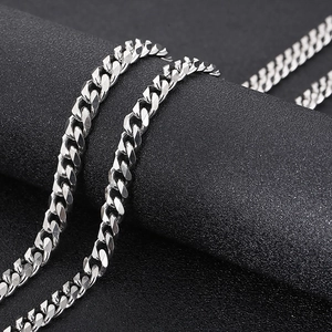 Macro shot of silver polished titanium steel cuban chain link necklace with smooth finish