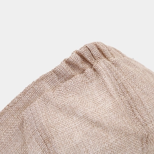 Detail view of breathable linen texture with internal mesh lining and elastic stitching